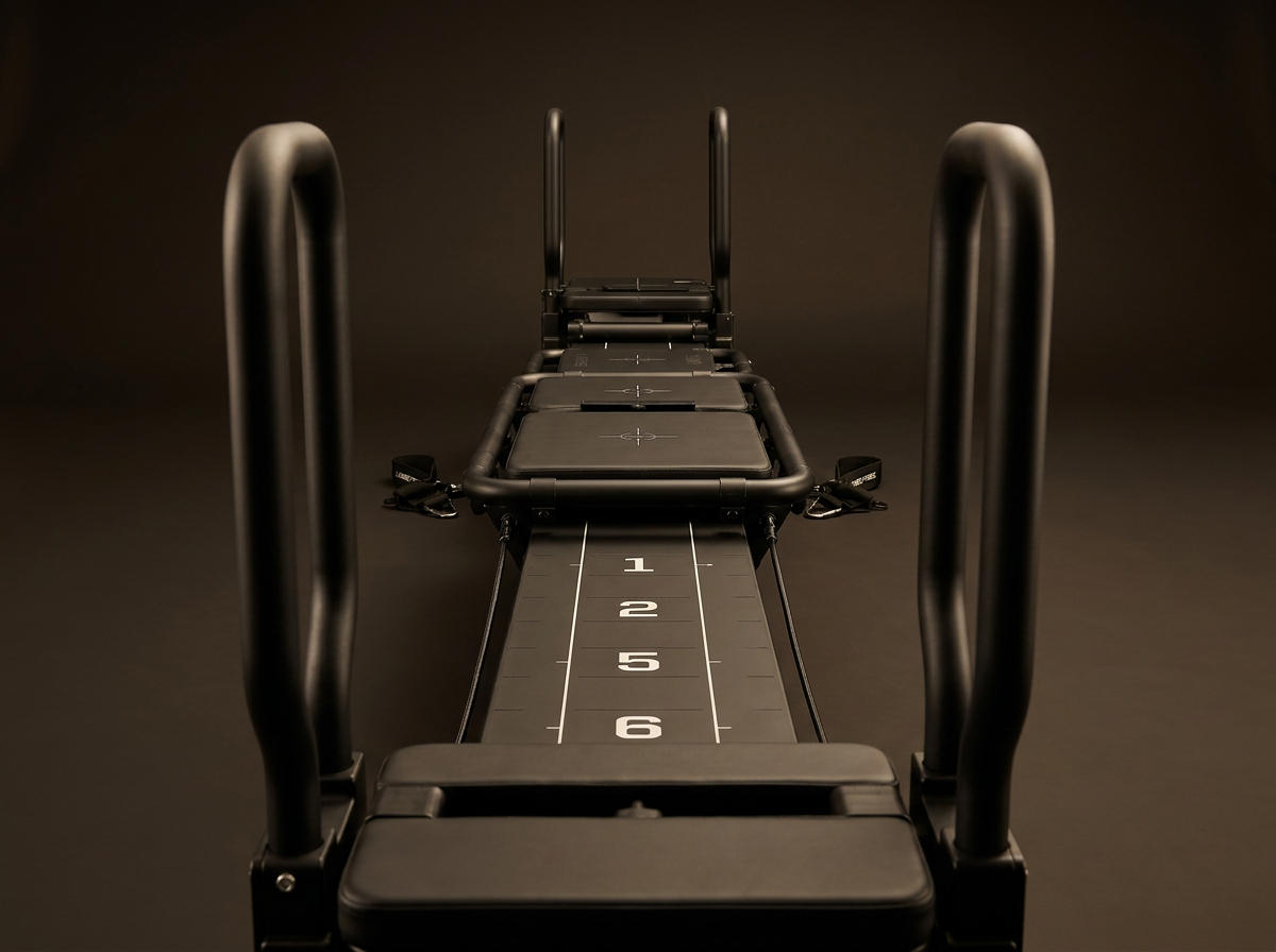 Lagree Mini Pro machine in a dark, minimal boutique studio.